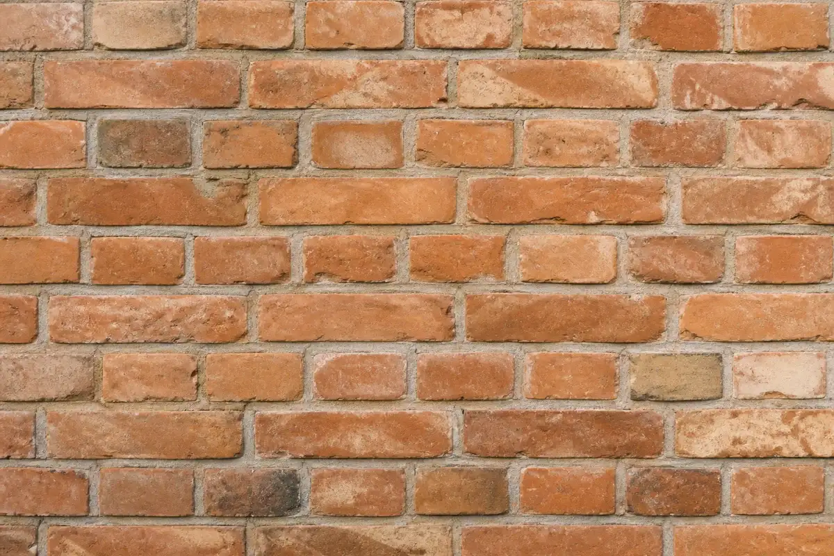 Close-up of a brick wall where removed text is filled in naturally